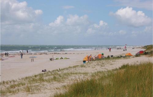 a group of people on a beach with tents at Holiday Home Tane Hedevej Blåvand X in Blåvand