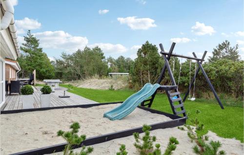 a playground with a slide in the sand at Gorgeous Home In Blåvand With Sauna in Blåvand
