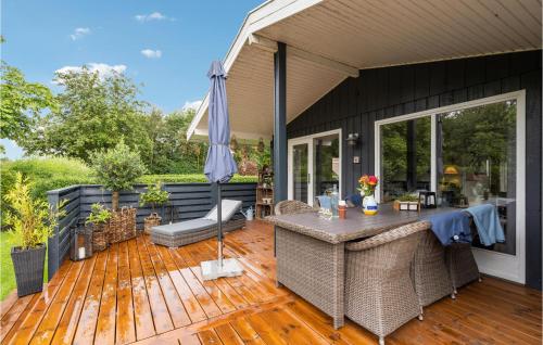 an outdoor patio with a table and an umbrella at Amazing Home In Hemmet With Wifi in Hemmet