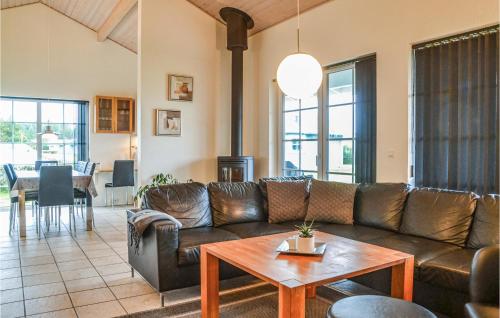 a living room with a leather couch and a table at Apartment Lønne Feriepark , Seawest M-941 in Lønne Hede