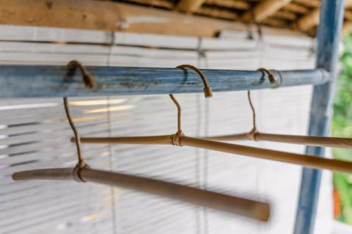 two metal hoses are hanging from a building at The Onion Collective in Ubud