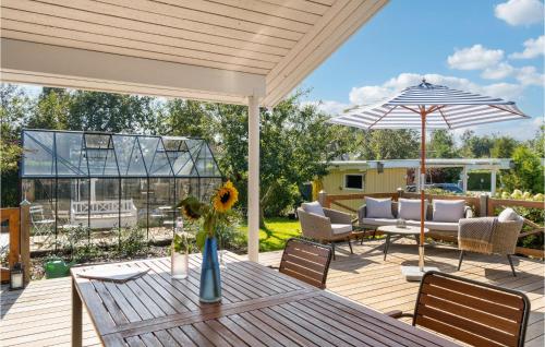 a patio with a table and an umbrella at 3 Bedroom Stunning Home In Gilleleje in Gilleleje