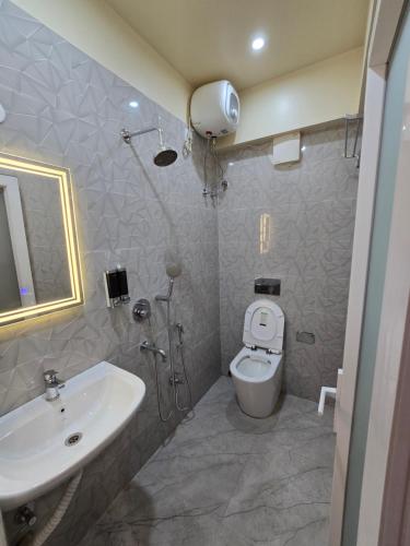 a bathroom with a sink and a toilet and a shower at Step Home in Kolkata