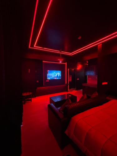a living room with a couch and a tv at The Royal Suites Gomti Nagar Lucknow in Lucknow