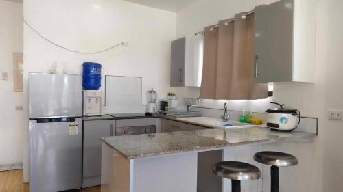 a kitchen with a refrigerator and a sink at Rice Field View Apartment in Mahilaom