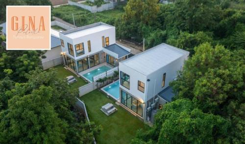 an aerial view of a house with a swimming pool at Gina Poolvilla89 Pattaya-Bangsaray to beach 900M in Bang Sare