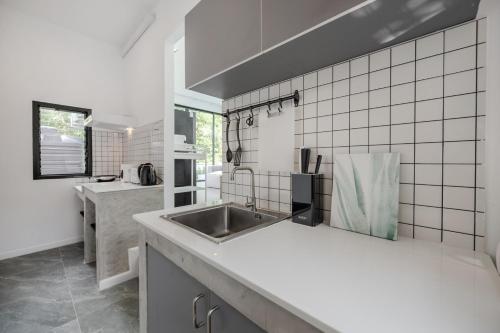 a kitchen with a sink and a counter top at Gina Poolvilla89 Pattaya-Bangsaray to beach 900M in Bang Sare