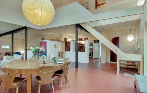 a dining room with a wooden table and chairs at Amazing Home In Sejerø With Kitchen in Sejerby