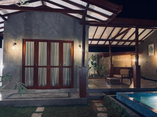 a house with a swimming pool next to a house at Moonrise villa in Tangalle