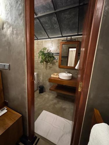 a bathroom with a sink and a mirror at Moonrise villa in Tangalle