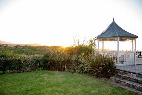 a gazebo sitting on top of a wooden deck at Kennedys Beach Villa in Hermanus