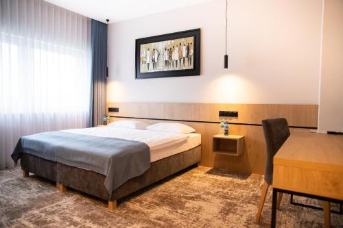 a hotel room with a bed and a desk at Sarmata in Czyżówek