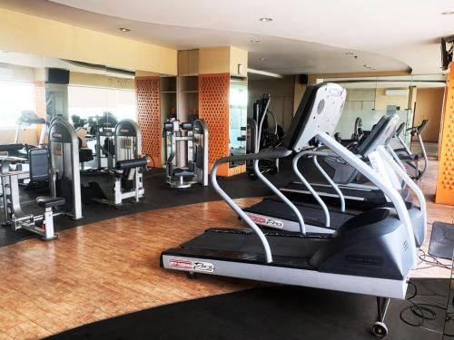 a gym with a treadmill and other equipment at Grand Serpong Hotel in Panunggangah