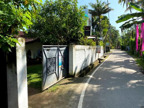 a street with a gate on the side of a road at Rai Family Guest in Matara