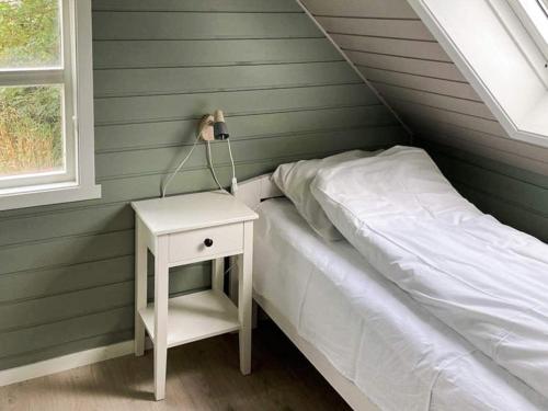 a bedroom with a bed and a nightstand with a lamp at 12 person holiday home in Selje-By Traum in Selje