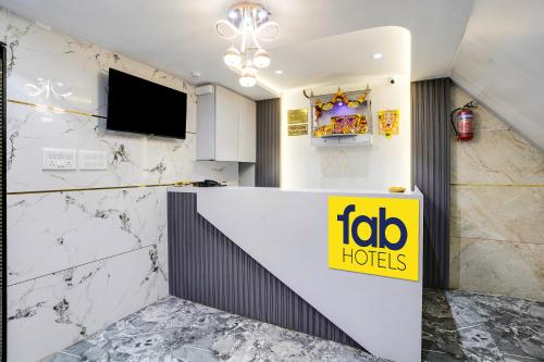 a hotel lobby with a mobo hotel sign on a wall at FabHotel RR Residency - Near BKC in Mumbai