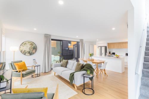a living room with a couch and a table at Chatham Street - Christchurch Holiday Homes in Christchurch