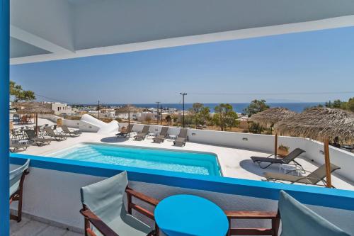 a swimming pool with a view of the ocean at Ancient Thera Apartments in Kamari
