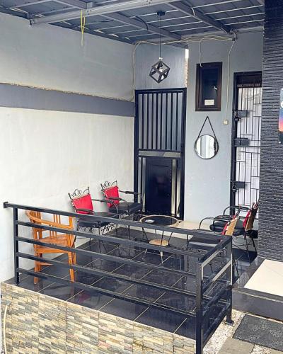 a patio with a table and chairs in a room at Guest House Pesona Alam in Cijoho