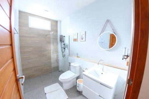 a bathroom with a toilet and a sink and a mirror at Banrao Pool Villa Khaoyai บ้านเราพูลวิลล่าเขาใหญ่ in Ban Tha Maprang