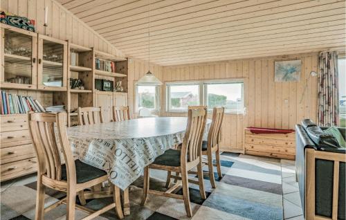 a dining room with a table and chairs at Holiday Home Strandvænget Slagelse in Strandlyst