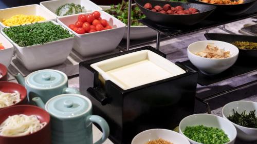 a buffet with different types of vegetables in bowls at Nishitetsu Grand Hotel in Fukuoka