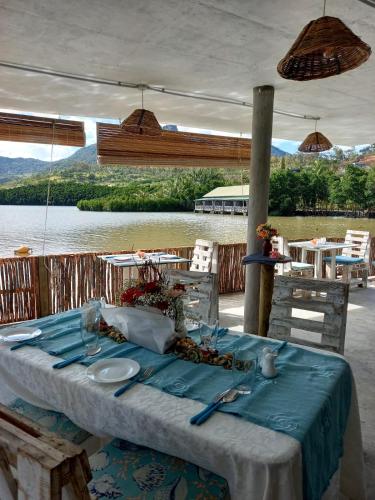 a table with a blue tablecloth on a table with a view at La Case Du Pecheur in Grand Sable