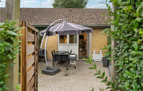 a patio with a table and an umbrella at Cozy Apartment In Middelfart With Wifi in Middelfart