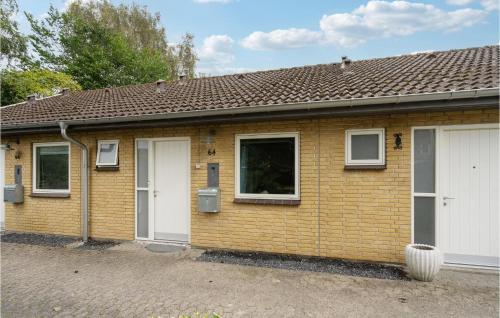 uma pequena casa de tijolos com duas portas brancas em Cozy Apartment In Middelfart With Wifi em Middelfart