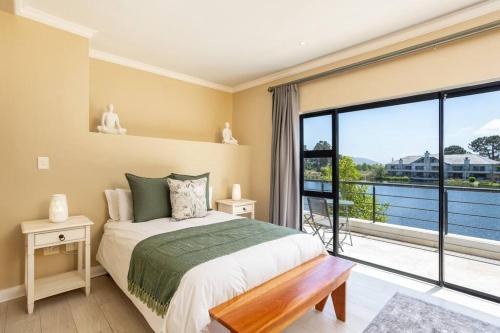 a bedroom with a bed and a large window at Luxury Lodge 4F Pearl Valley Golf Estate in Simondium