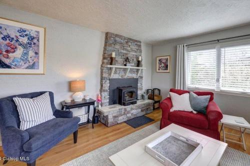a living room with two chairs and a fireplace at 3 Bedroom Beach Oasis - HOT TUB - Pet Friendly in Seaside