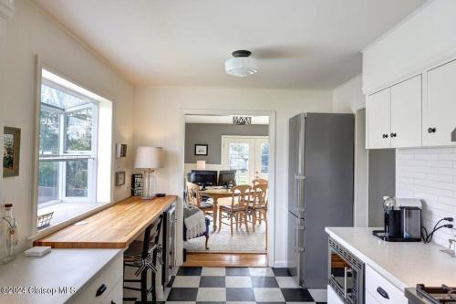 a kitchen with a counter and a dining room at 3 Bedroom Beach Oasis - HOT TUB - Pet Friendly in Seaside