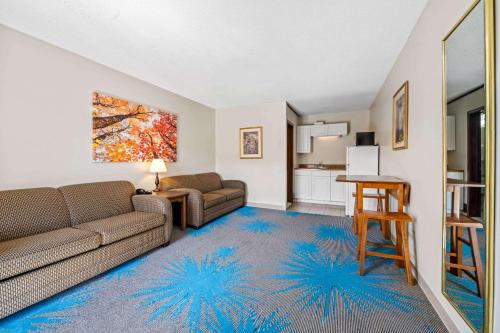 a living room with a couch and a table at Days Inn by Wyndham Dubuque in Dubuque