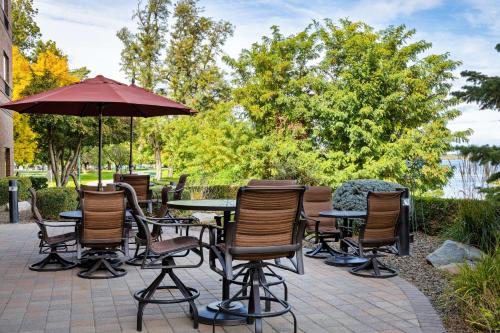a patio with tables and chairs and an umbrella at Hampton Inn Richland-Tri Cities in Richland