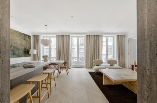 un salon avec une table et des chaises dans l'établissement Urban Flat 191 - Luxury 3 Bedroom Apartment - Madeleine, à Paris
