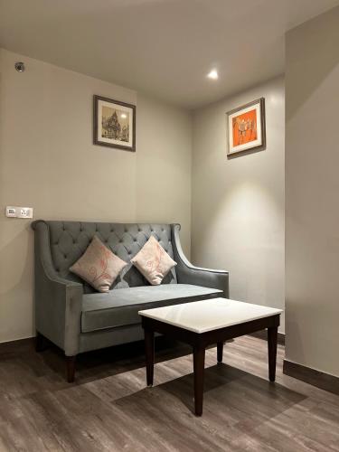 a living room with a couch and a coffee table at Hotel Apricia in Ludhiana