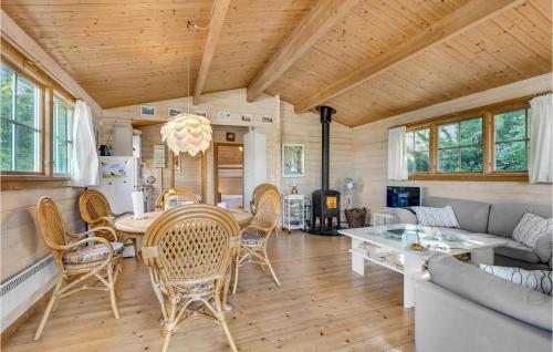 a dining room and living room with a table and chairs at Cozy Home In Bogø By With Wifi in Bogø By