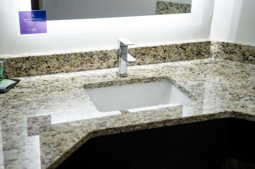 a sink in a bathroom with a counter at Sleep Inn & Suites West Knoxville in Knoxville