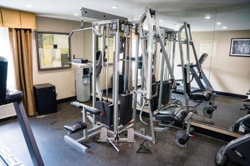 a gym with several tread machines in a room at Sleep Inn & Suites West Knoxville in Knoxville