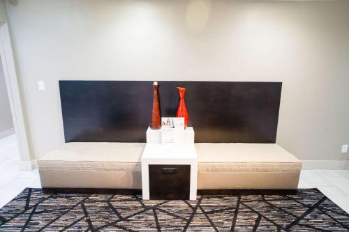 a bed with two vases sitting on a table at Sleep Inn & Suites West Knoxville in Knoxville