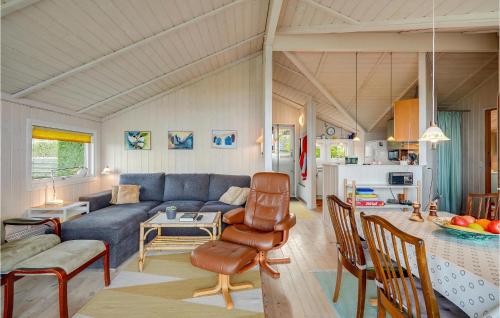 a living room with a couch and a table at Awesome Home In Allingåbro With Kitchen in Allingåbro