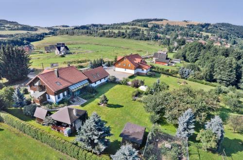 an aerial view of a house on a green field at Pension Jitka in Šimonovice