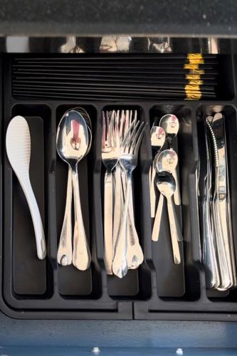 a drawer filled with utensils and spatulas at Thỏ Non Garden - Bảo Lộc Center #3BR in Bao Loc