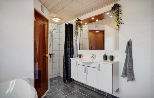 a bathroom with a white sink and a mirror at Amazing Home In Skjern With 5 Bedrooms, Sauna & Wifi in Skjern