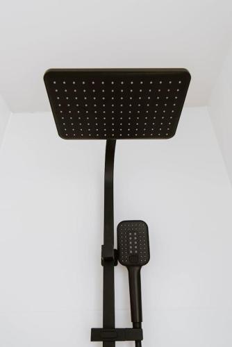 a black microphone on a stand on a white background at Joseph's Place - A Restful Retreat for Two in Mudgee