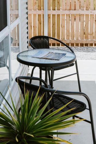 a table and chairs sitting next to a potted plant at Joseph's Place - A Restful Retreat for Two in Mudgee