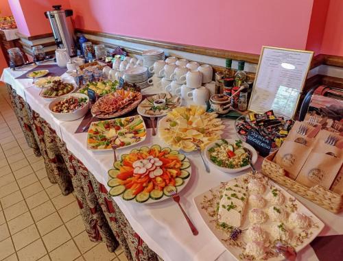 a long table with many plates of food on it at Jasny Dwór in Polanica-Zdrój