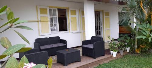 a house with two chairs on a porch at Chez Gilou in Rivière