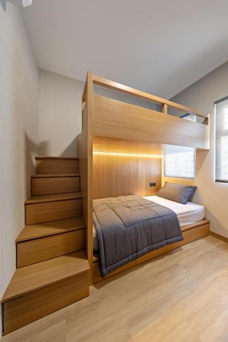 a bedroom with a bunk bed and a staircase at Newly Renovated 2BR Apt and Direct Mall Access in Jakarta
