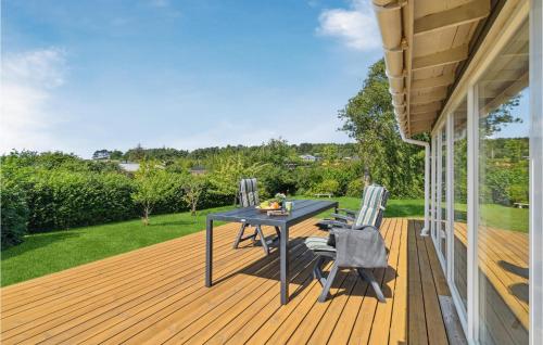 a patio with a table and chairs on a deck at Beautiful Home In Kalundborg With Wifi in Kalundborg